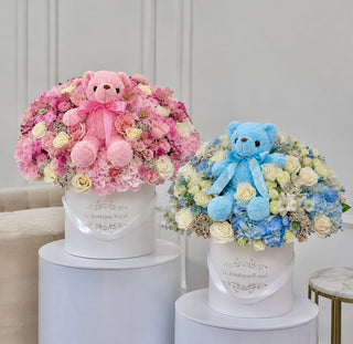 New baby flower arrangements in pink and blue with teddy bears by Le Boutique Royal