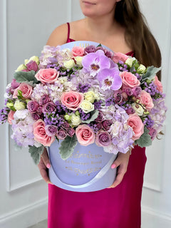 
                    
                      a woman holding beautiful flower arrangement
                    
                  