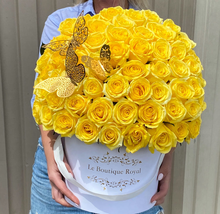 woman holding yellow roses in hands
