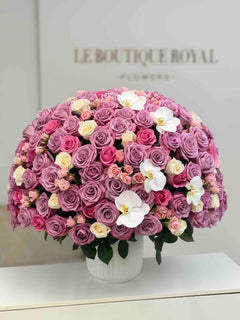 
                    
                      Luxury arrangement of lavender roses, pink spray roses, ivory roses, and white orchids in an elegant vase by Le Boutique Roya
                    
                  