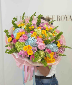 
                    
                      Ramo colorido con hortensias azules, rosas spray amarillas, rosas rosadas, claveles y flores de temporada.
                    
                  