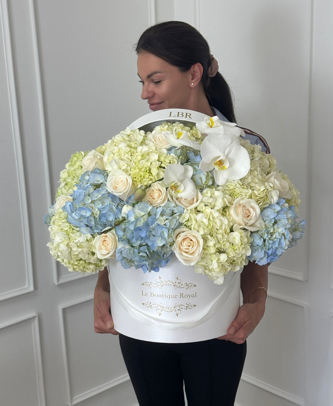 luxury hydrangeas and roses in a hta box with a woman