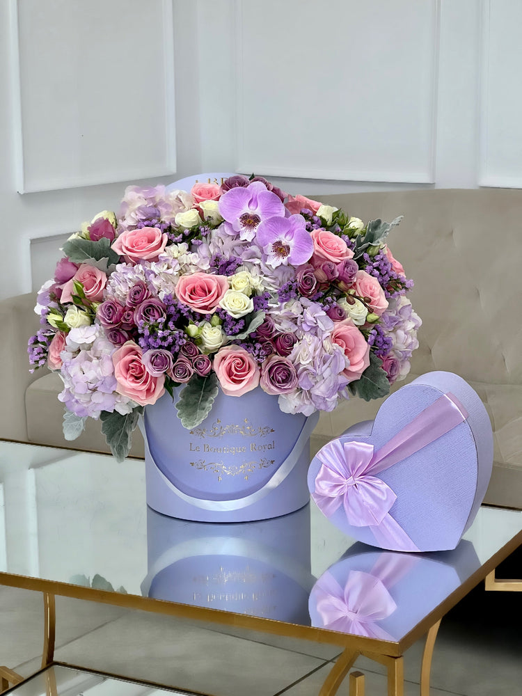 lavender flower arrangement with a heart shape box