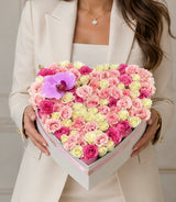 Luxury heart-shaped flower box with pink and white roses and a purple orchid by Le Boutique Royal in Miami.