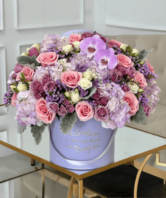 
                    
                      mixed flower arrangement of purple flowers in a lavender box vase
                    
                  