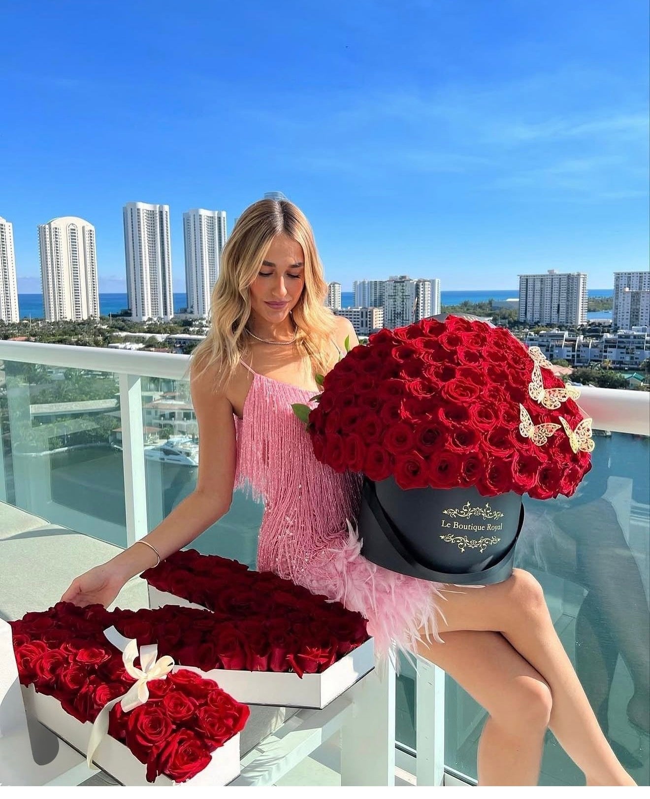 Le Boutique Royal customer gallery with red roses overlooking Miami