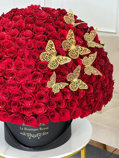 
                    
                      gold butterflies and red roses in a vase
                    
                  
